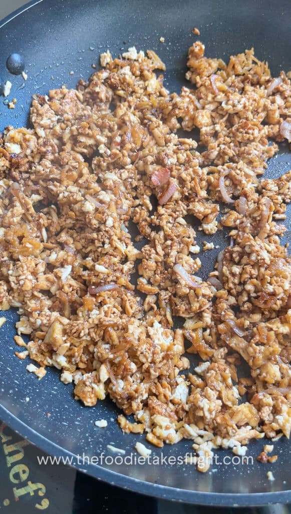 Cooking down tofu crumble in savory sauce