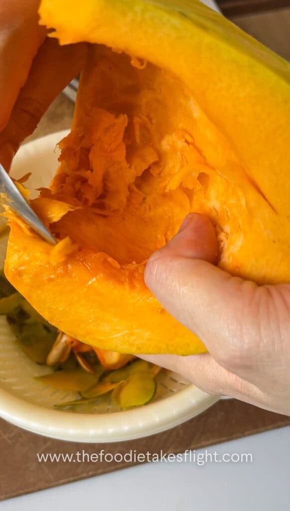 Scooping seeds out of the squash