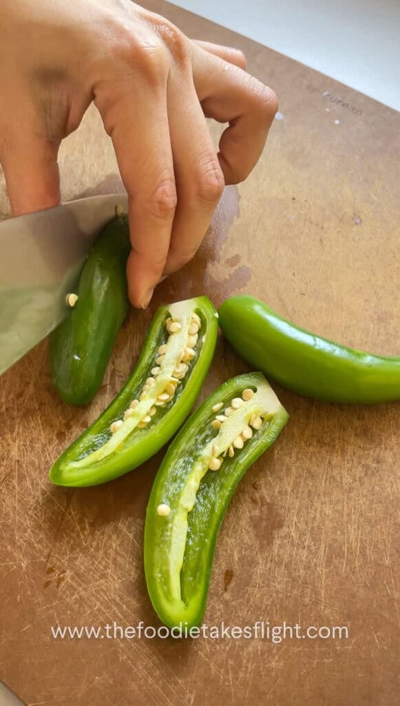 Scooping seeds out of serrano peppers
