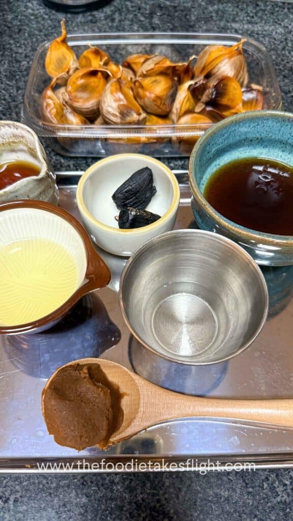 flat lay of ingredients for black garlic miso dressing
