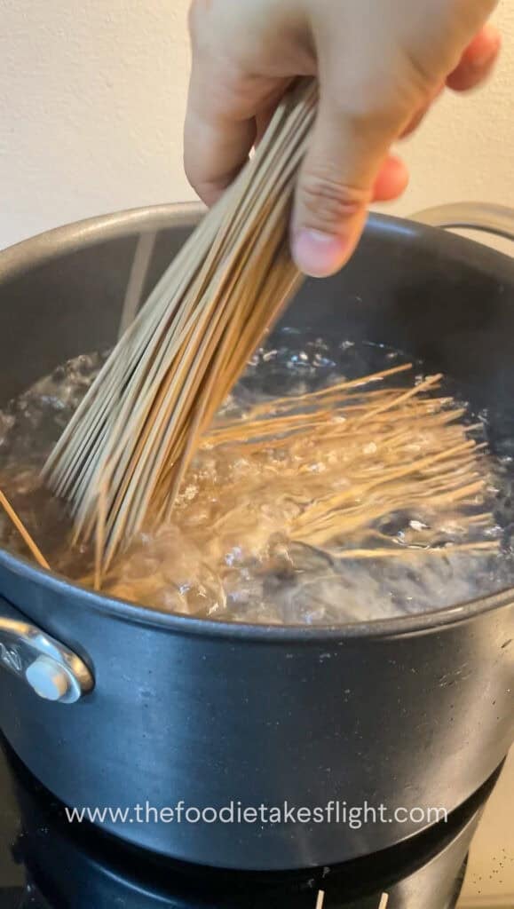 bundle of soba noodles in a pot of boiling water