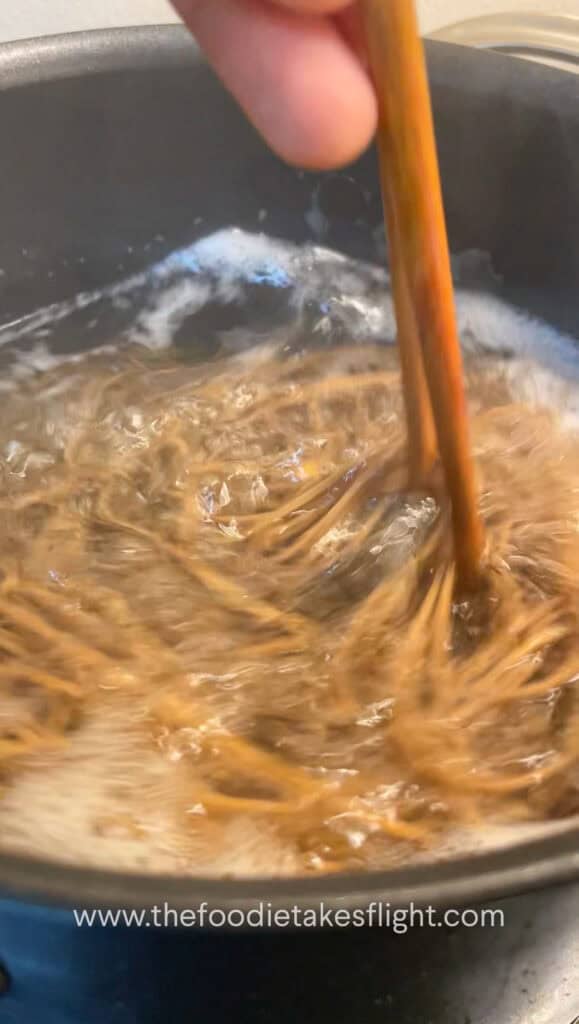 bundle of soba noodles in a pot of boiling water