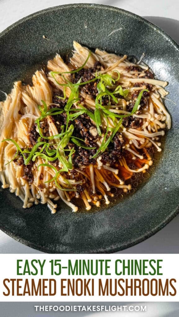 Plate of steamed enoki mushrooms topped with garlic, chili, green onions, and a drizzle of sesame oil.