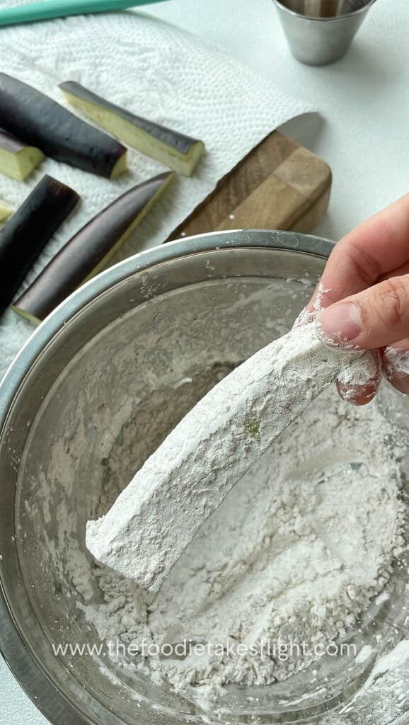 Coating eggplant in corn starch before frying