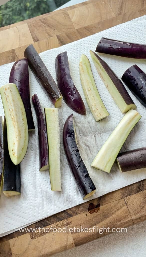 Sliced chinese eggplant in batons on a paper towel