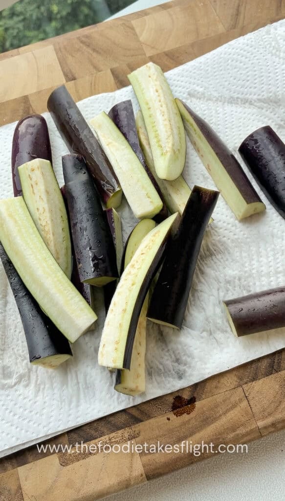 Sliced chinese eggplant in batons on a paper towel