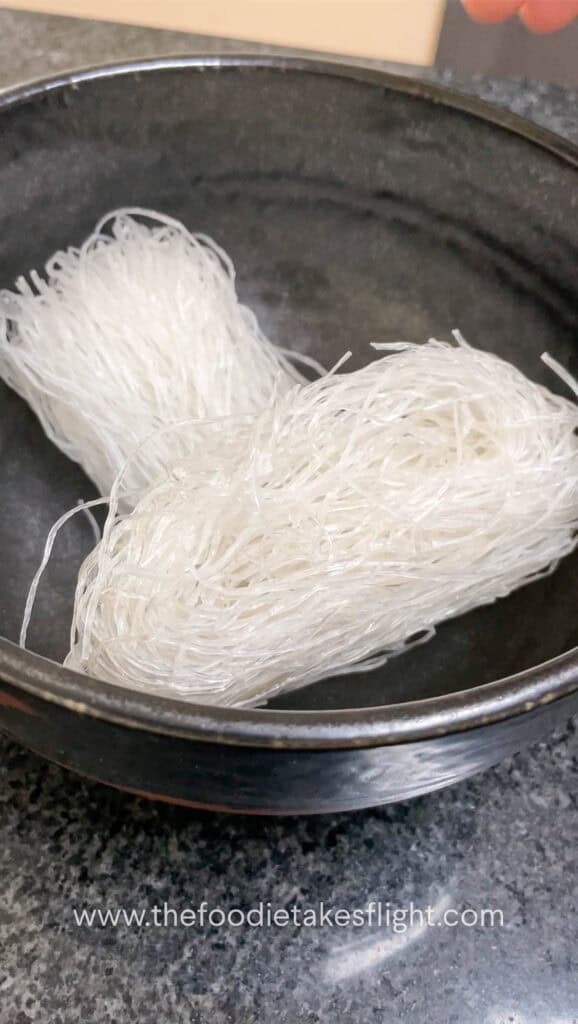 Bundles of vermicelli noodles in a black bowl