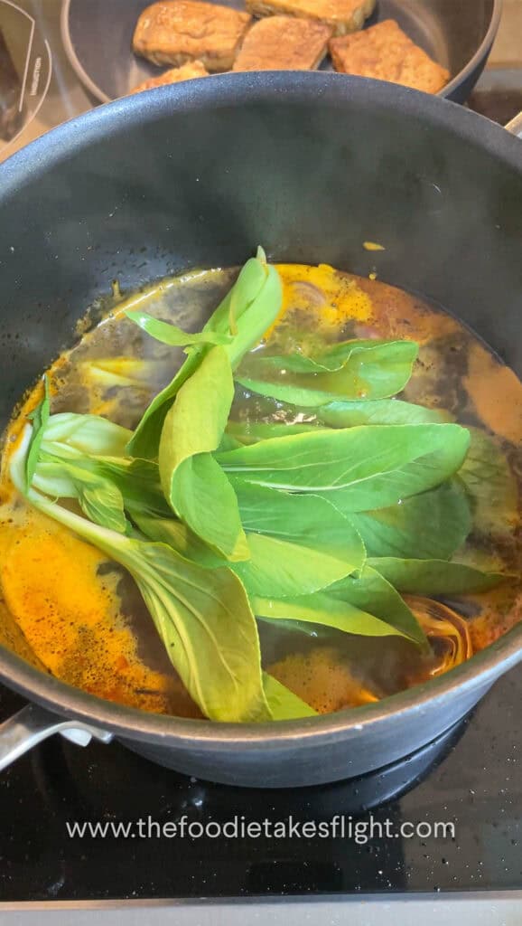 Blanching the bok choy in soup pot