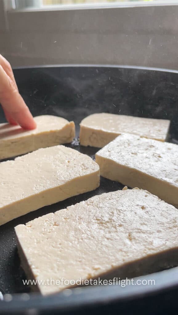 Pan frying extra firm tofu in a skillet