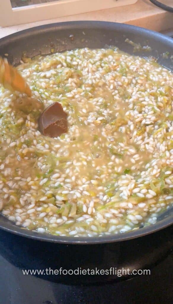 Adding white miso paste into the risotto halfway through cooking.