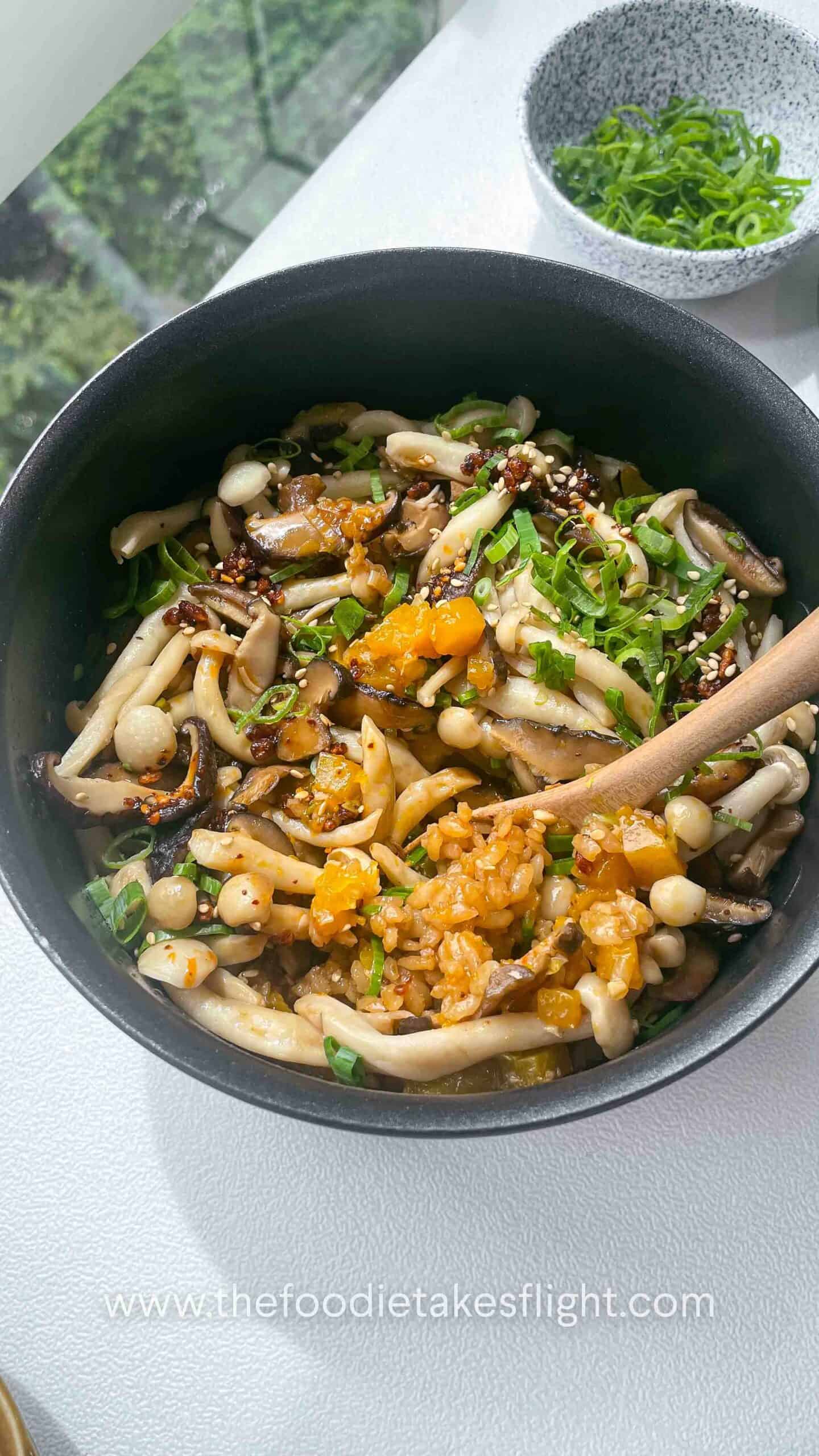 Close-up of fluffy rice mixed with chunks of golden pumpkin and mushrooms