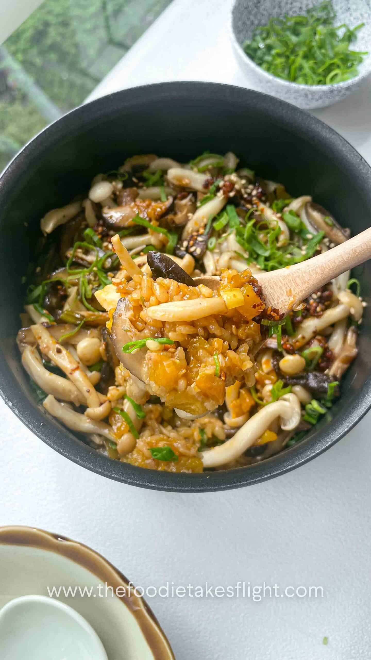 	Close-up of fluffy rice mixed with chunks of golden pumpkin and mushrooms