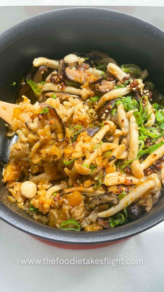 one-pot pumpkin mushroom rice topped with green onions, chili oil, and crispy fried shallots.