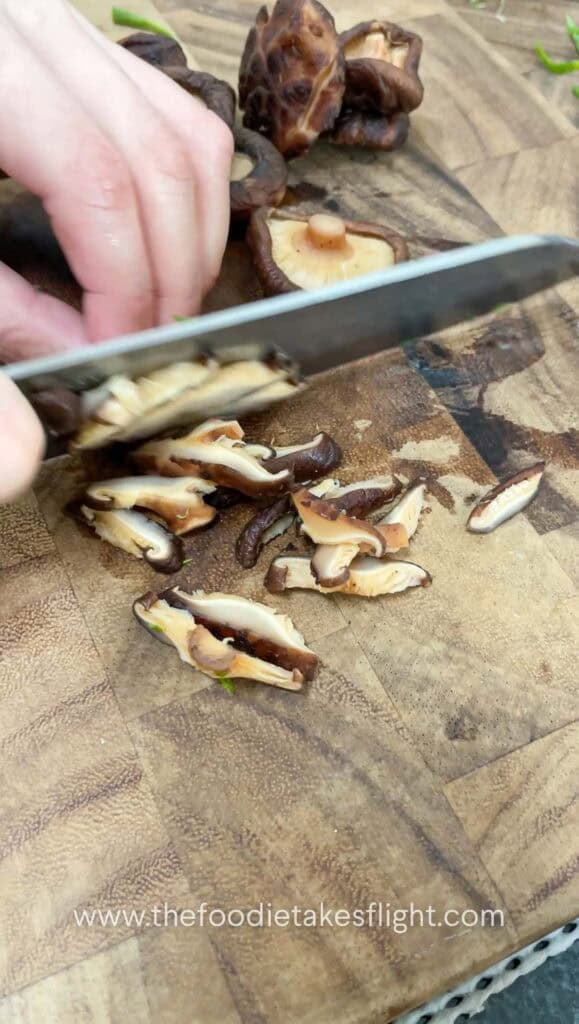 thinly slicing shiitake mushrooms