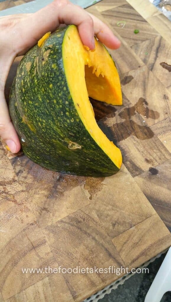 wedge of pumpkin on a cutting board