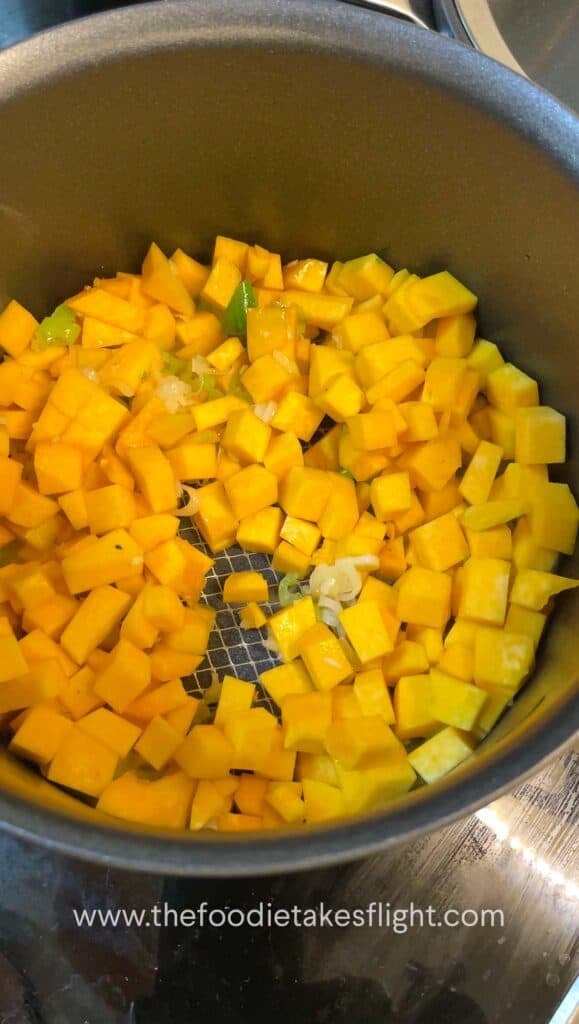 diced yellow pumpkin cooking down in a pot