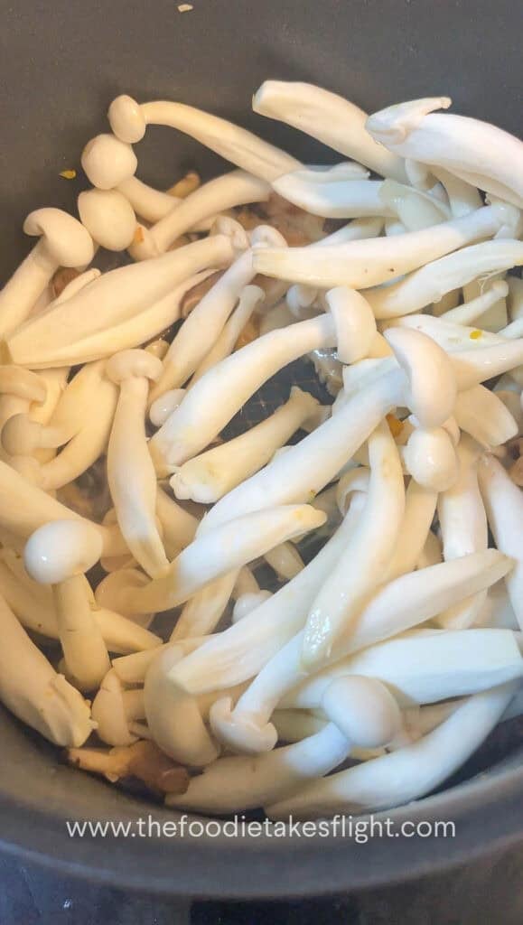 Mushrooms being sautéed until browned and fragrant in the same pot