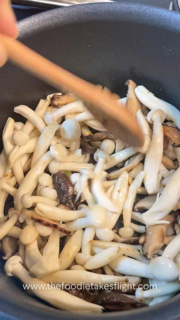 Mushrooms being sautéed until browned and fragrant in the same pot