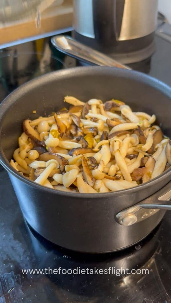 Steaming pot of pumpkin mushroom rice after cooking, ready to fluff