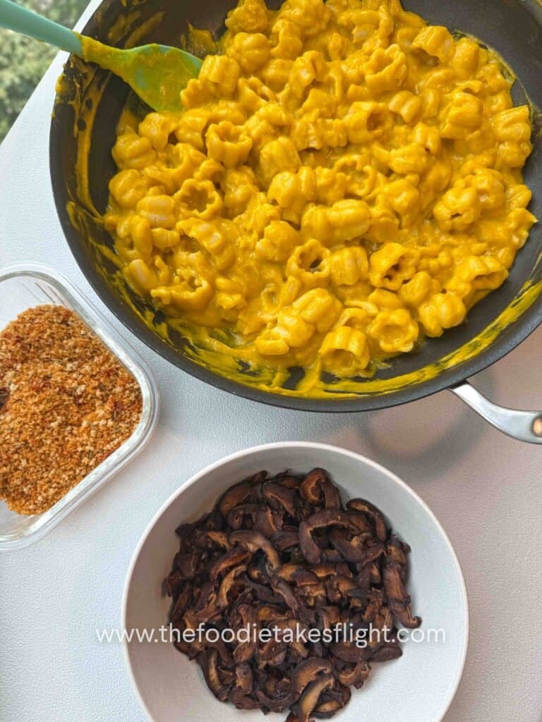 overlay of pumpkin miso pasta, shiitake mushroom bacon, and Calabrian chili breadcrumbs