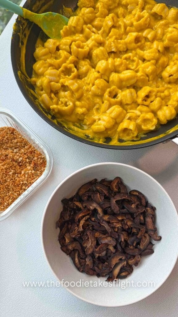 overlay of pumpkin miso pasta, shiitake mushroom bacon, and Calabrian chili breadcrumbs