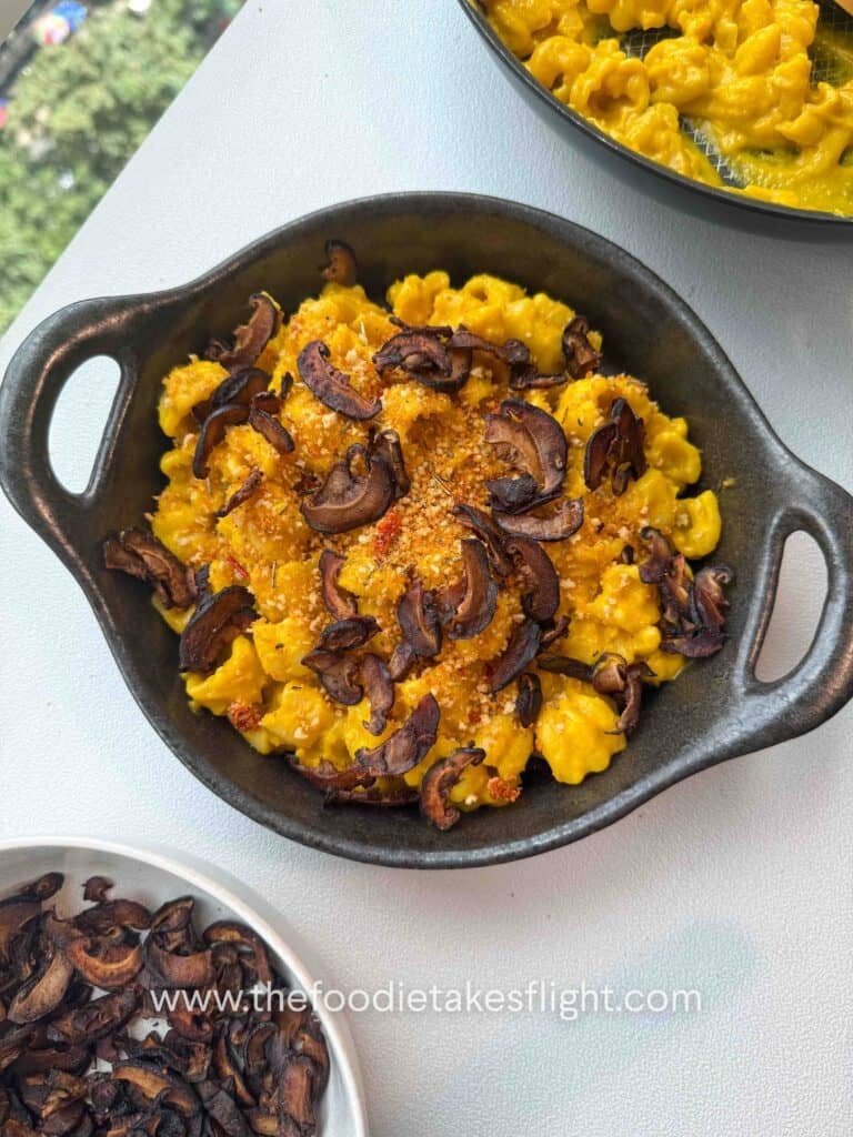 Finished pumpkin miso pasta garnished with chili breadcrumbs and shiitake bacon on a g