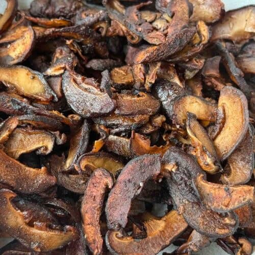 close up of shiitake mushroom bacon in a white bowl