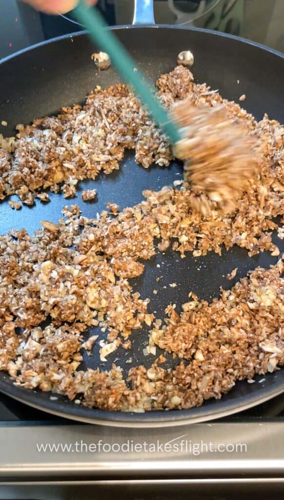 cooking down minced mushroom filling in a non stick pan