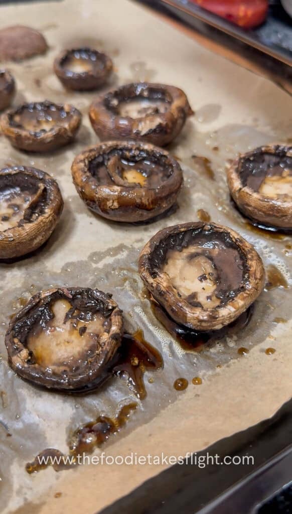 baked mushrooms on a parchment paper lined tray