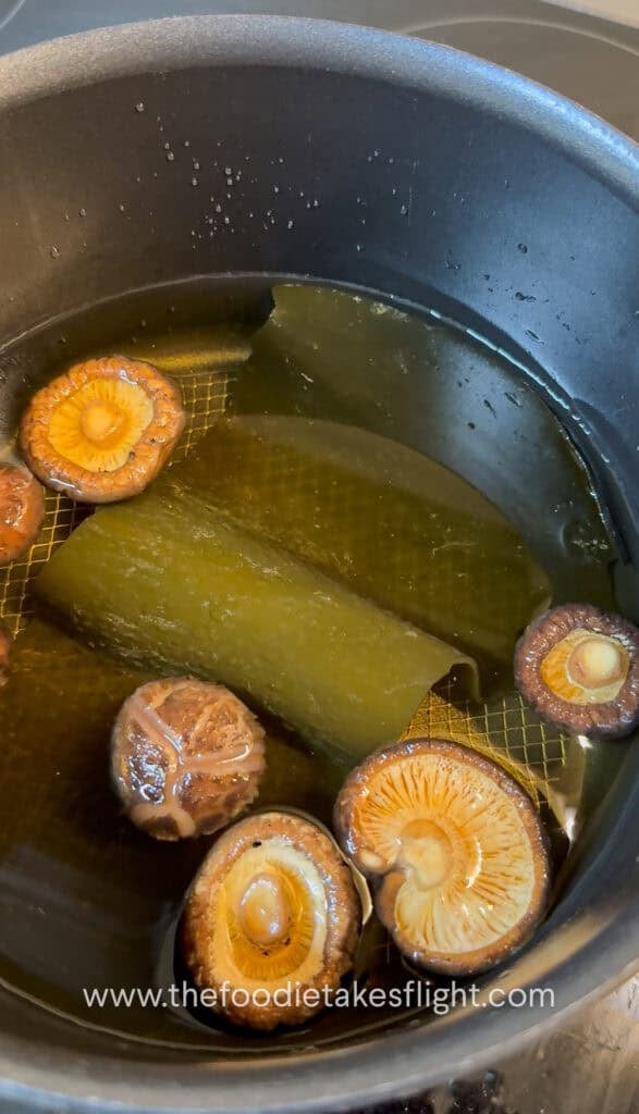 Kombu and dried shiitake mushrooms soaking in water to make broth