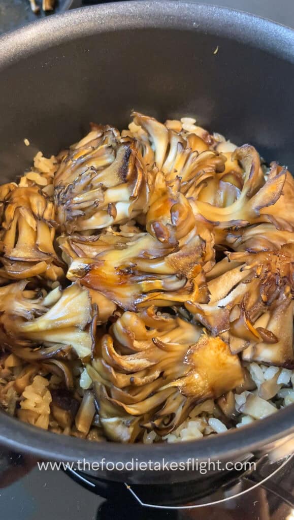 maitake mushrooms over cooked pot rice
