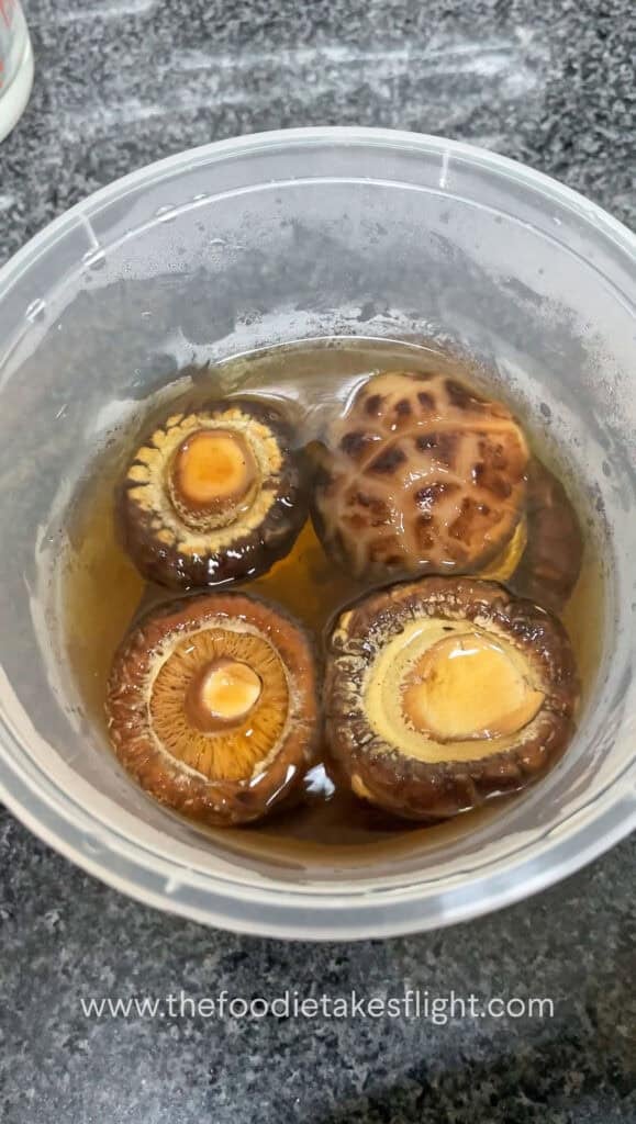 rehydrated shiitake mushrooms in a plastic deli container