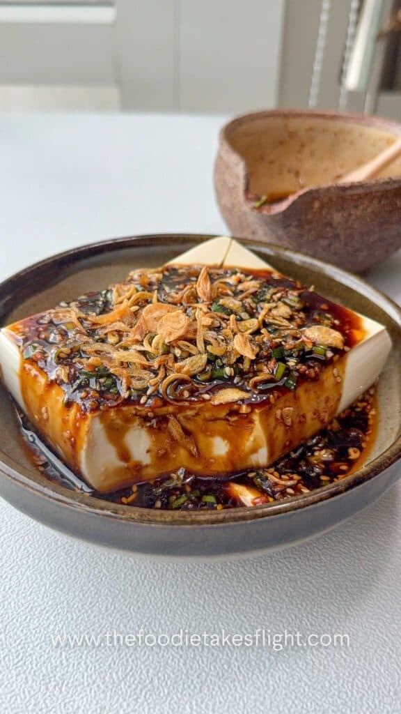 All-around dipping sauce poured over cold silken tofu and topped with fried shallots