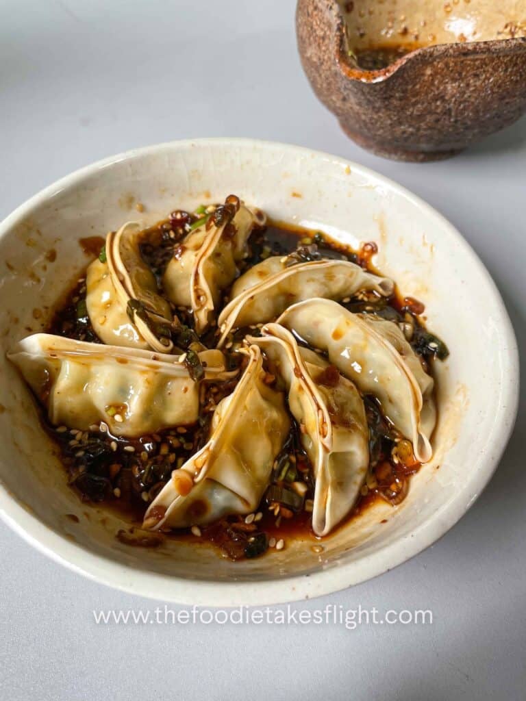 Dumplings served with garlic chili dipping sauce