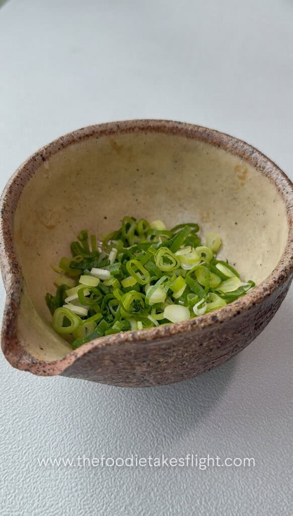 sliced green onions in a heat proof bowl