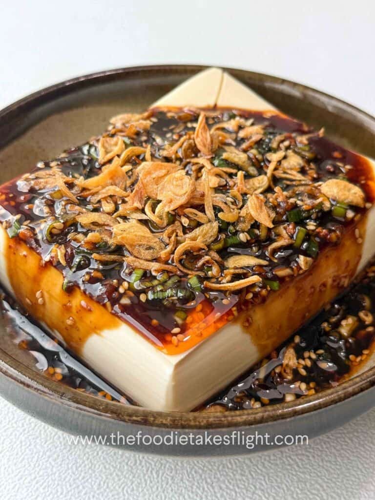 All-around dipping sauce poured over cold silken tofu and topped with fried shallots