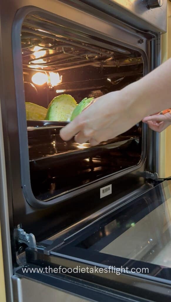 Cabbage wedges on a tray being placed in a preheated oven