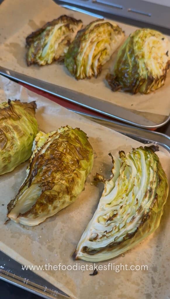 roasted cabbage wedges on a lined baking tray