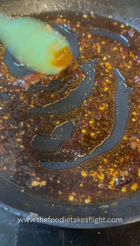 Gochujang butter sauce simmering in a pan with mirin and soy sauce