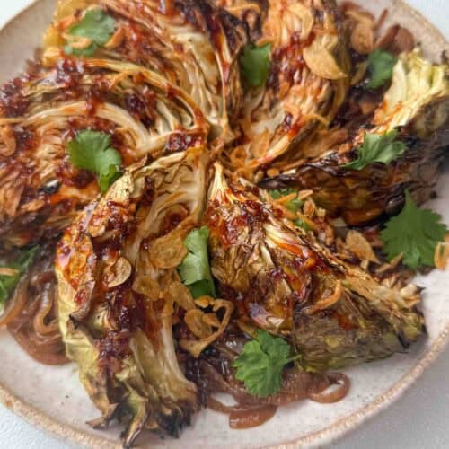 Charred cabbage wedges served over caramelised onions and drizzled with gochujang butter sauce
