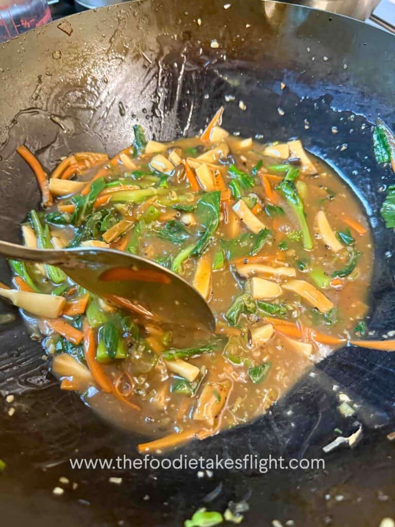 Savory gravy thickening in a wok with cornstarch