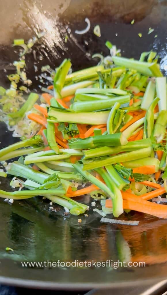 Vegetables and mushrooms stir-fried in a wok before adding gravy
