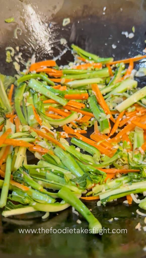 Vegetables and mushrooms stir-fried in a wok before adding gravy
