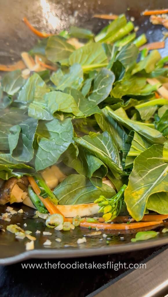 Vegetables and mushrooms stir-fried in a wok before adding gravy
