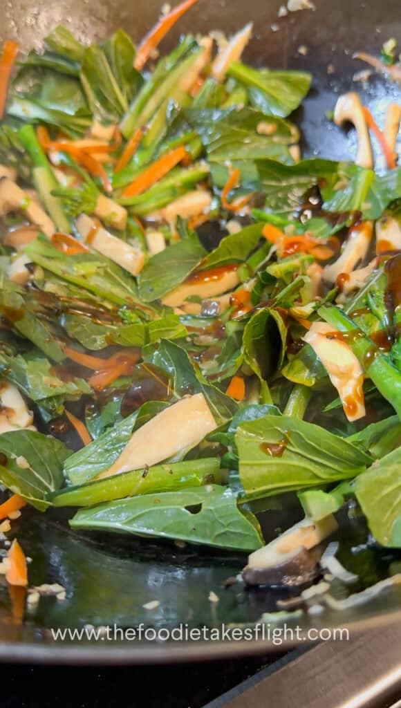 Vegetables and mushrooms stir-fried in a wok before adding gravy