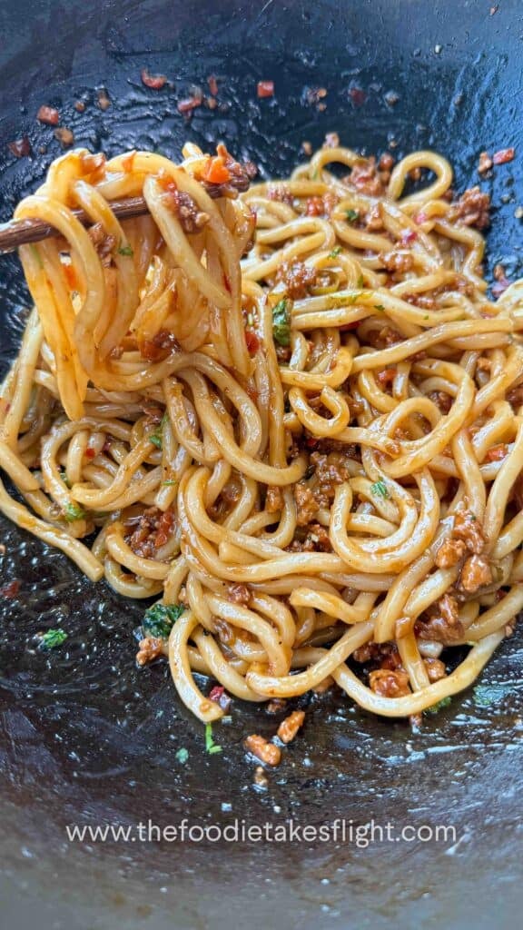 calamansi udon noodles tossed in glossy soy citrus sauce with crumbled tofu and peppers