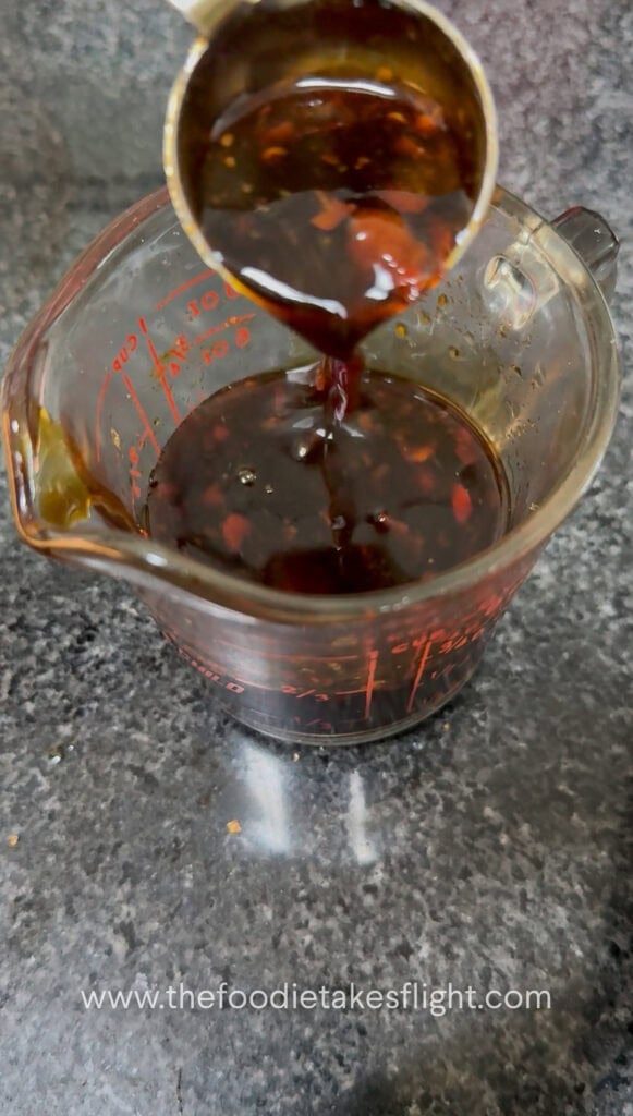 Calamansi juice being mixed with soy sauce and seasonings for noodle sauce