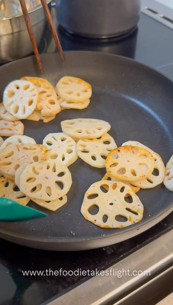 Lotus root browning in a skillet until golden and crisp