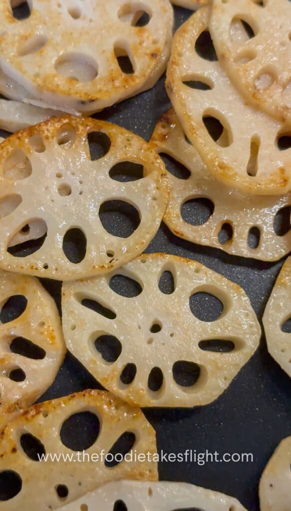 Lotus root browning in a skillet until golden and crisp
