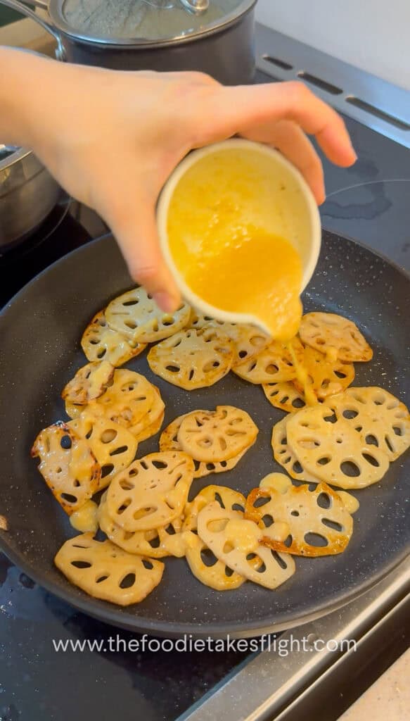 Lemon miso sauce being poured over pan-fried lotus root